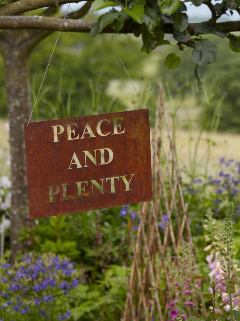 Rusty Peace and Plenty Sign